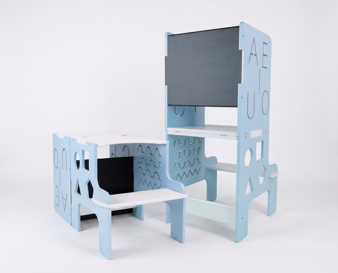 Torre de aprendizaje multifuncional en acabado gris usada como escritorio infantil junto a monitor